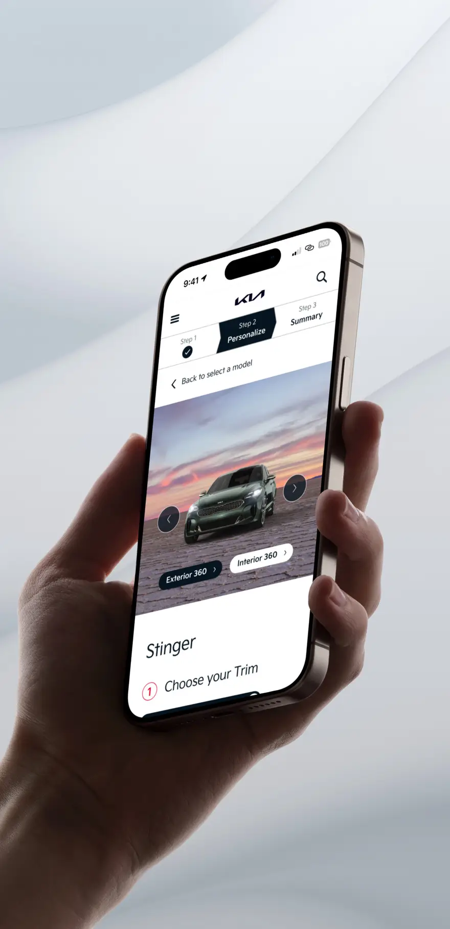 Hand holding a phone showing the Kia car configurator personalizing a green Stinger