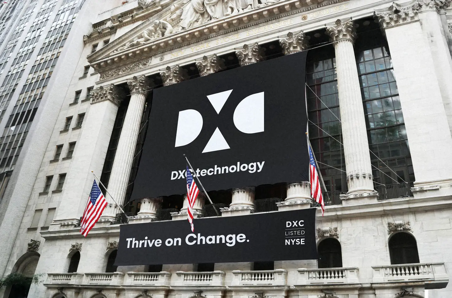 Large DXC.technology “Thrive on Change.” banner draped across the New York Stock Exchange facade