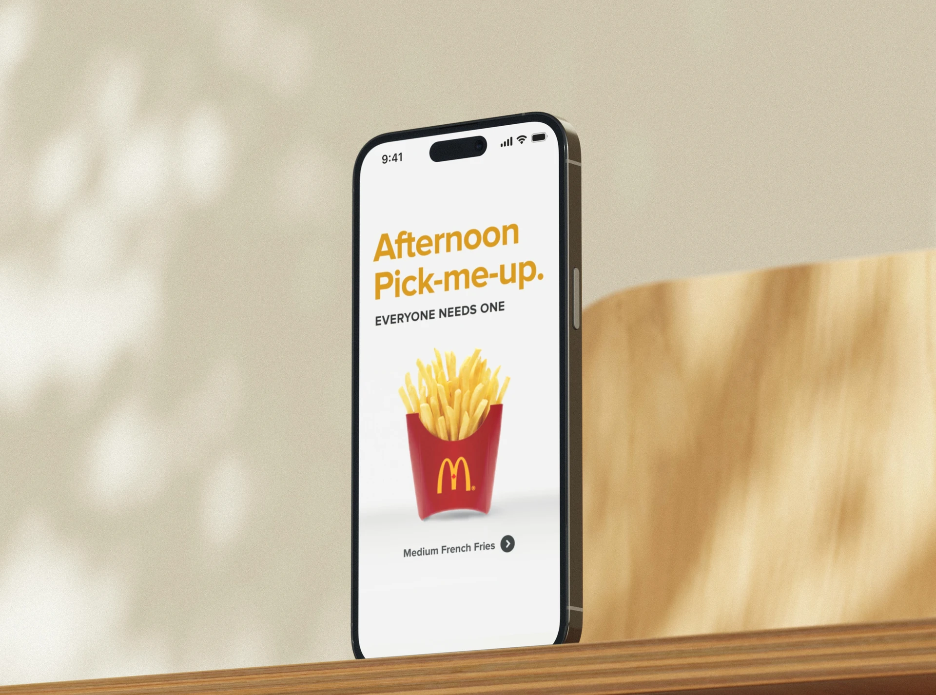 McDonald’s app promo screen on a phone advertising medium fries as an afternoon pick-me-up