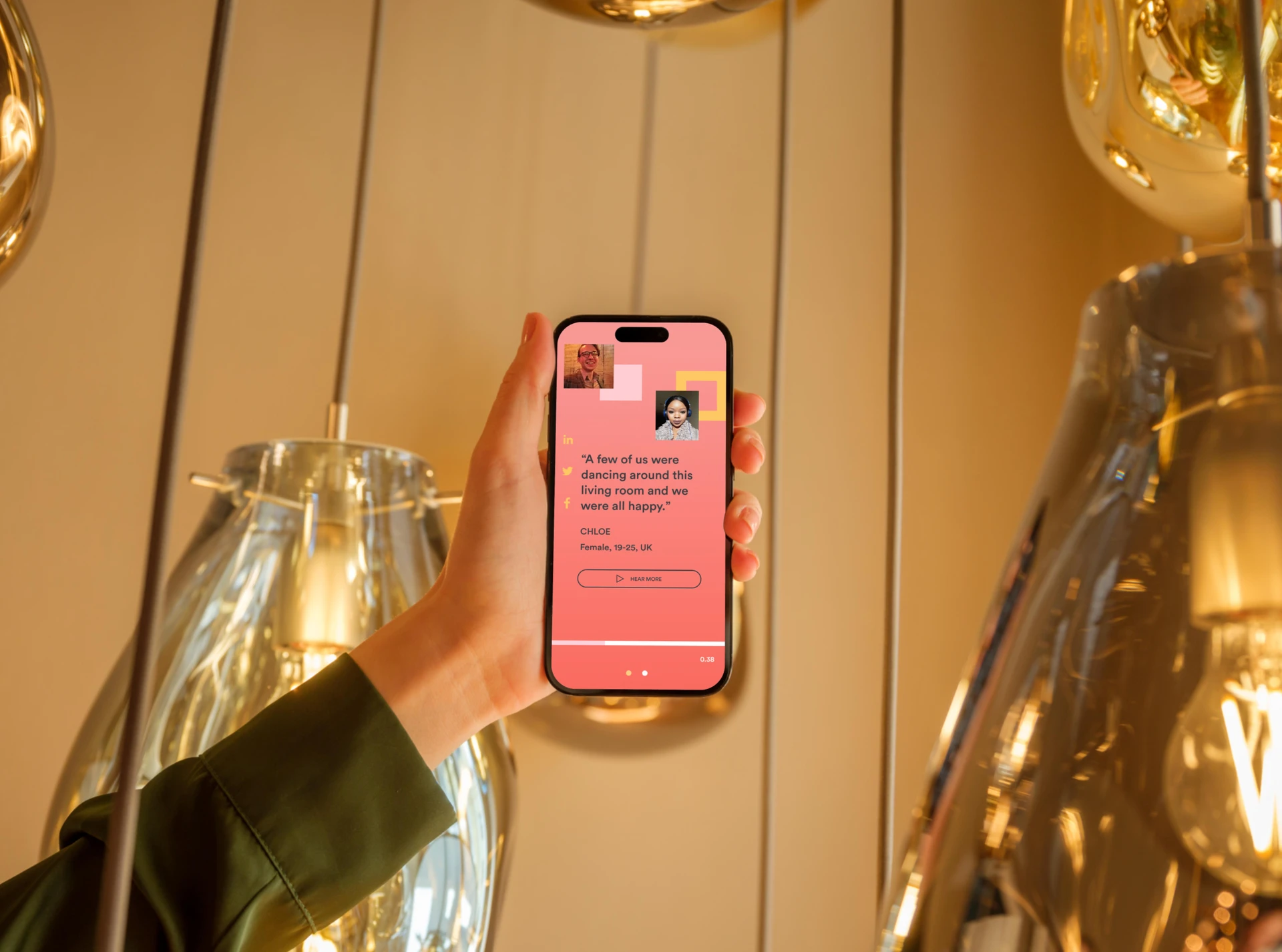 Hand holding a phone showing a Spotify for Brands listener quote card, framed by glowing pendant lights