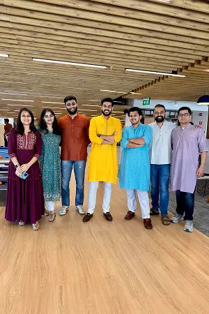 Konrad team members in vibrant traditional attire posing together