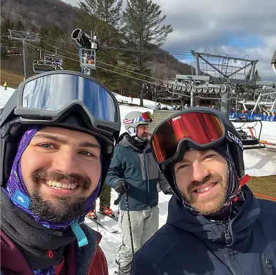 Two Konrad team members in ski goggles and winter gear on a mountain